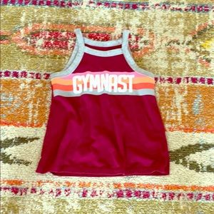 A Justice tank top with gymnast across it